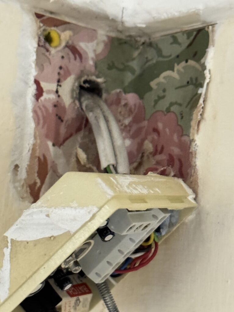 Old lounge wallpaper found behind the alarm motion detector