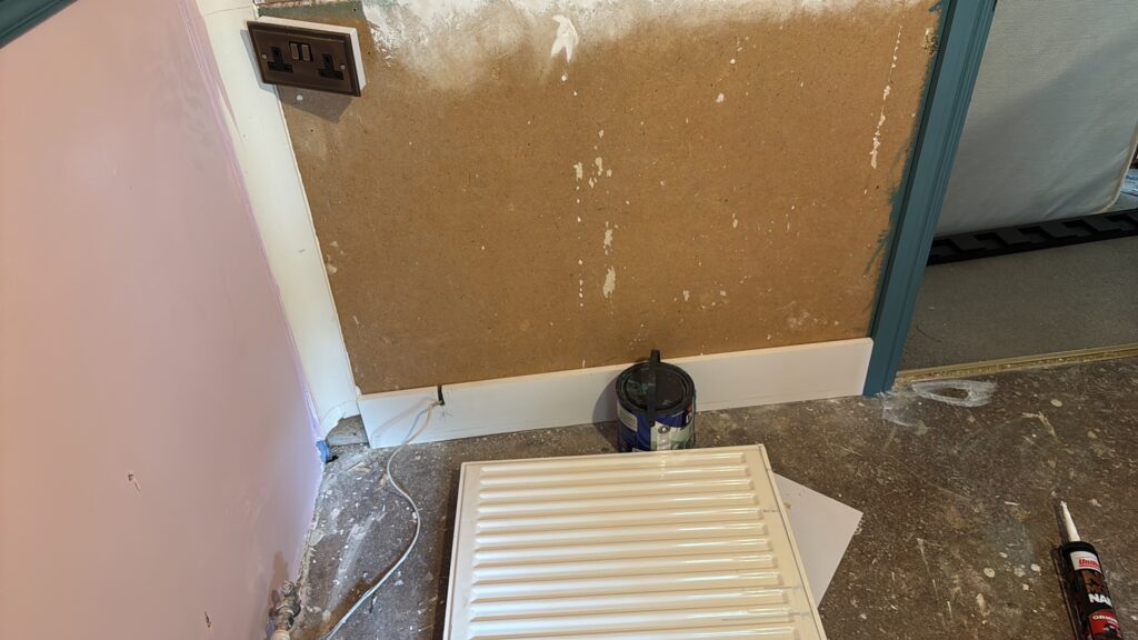 Stud wall skirting cut to allow access for the analogue phone cable