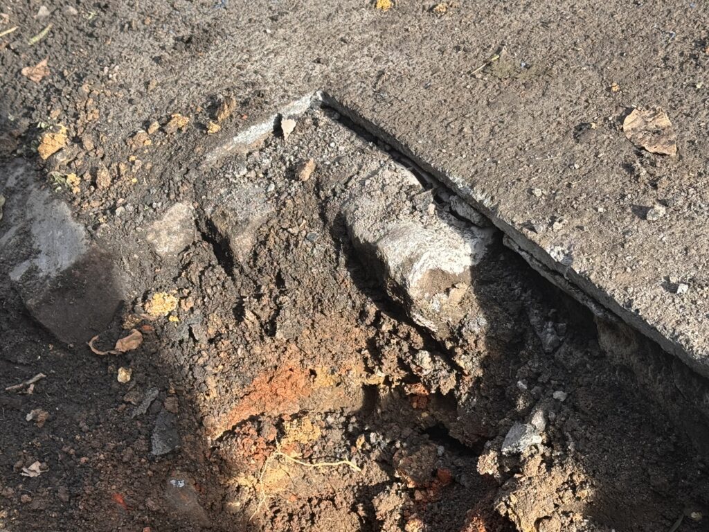 Traces of the granite sets that would have been the original street covering in years gone by foujd under the modern tarmac.