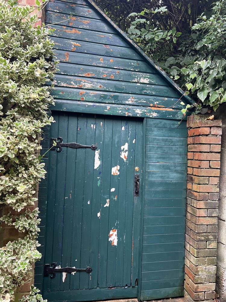 The lean-to partway through being stripped. Two shade of green, a dark blue and a white showing so far!