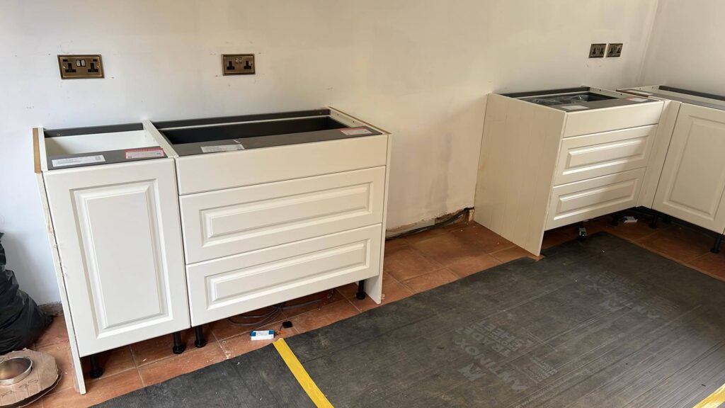 More cupboards in place alog with teh brass power sockets